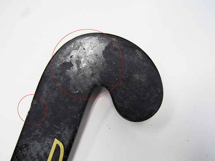 Field hockey stick showing chips.